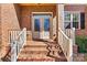 Charming brick home entrance with decorative glass front door and brick steps at 106 Wolf Hill Dr, Mooresville, NC 28117