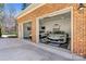 Detached two-car garage with luxury sport cars on a checkered floor and a visible tv at 106 Wolf Hill Dr, Mooresville, NC 28117