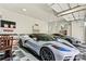 Luxury vehicles displayed inside the garage with checkered floors and plenty of room for storage at 106 Wolf Hill Dr, Mooresville, NC 28117