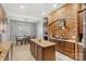 Modern kitchen with brick accent wall, granite countertops, and stainless steel appliances at 106 Wolf Hill Dr, Mooresville, NC 28117