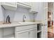 Laundry area featuring gray walls, white cabinets, and utility sink at 106 Wolf Hill Dr, Mooresville, NC 28117