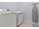 Laundry area featuring modern washer and dryer with an ironing board at 106 Wolf Hill Dr, Mooresville, NC 28117