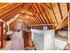 Spacious unfinished attic with exposed wooden beams and natural light, offering potential for customization at 106 Wolf Hill Dr, Mooresville, NC 28117