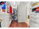 Organized walk-in closet featuring custom shelving, drawers, and hardwood flooring at 106 Wolf Hill Dr, Mooresville, NC 28117