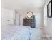 Cozy bedroom featuring soft carpeting, a decorative mirror, and a classic wooden dresser at 1199 Blackburn Cir, Edgemoor, SC 29712