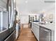 Modern kitchen featuring stainless steel appliances, white cabinets, and an open layout to the living room at 1199 Blackburn Cir, Edgemoor, SC 29712