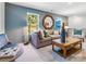 Comfortable living area featuring gray furniture, a wooden mirror, and serene natural lighting at 1199 Blackburn Cir, Edgemoor, SC 29712