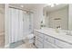 Bathroom featuring a shower-tub, a vanity with a large mirror, and decorative accents at 12028 Regal Lily Ln, Huntersville, NC 28078