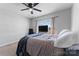 Comfortable bedroom with a ceiling fan, a big window, and a bed with a blue blanket at 12028 Regal Lily Ln, Huntersville, NC 28078