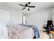 This bright bedroom has a ceiling fan and a comfortable bed at 12028 Regal Lily Ln, Huntersville, NC 28078