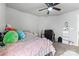 This bedroom includes a ceiling fan, a cozy bed with decorative pillows, and a functional workspace at 12028 Regal Lily Ln, Huntersville, NC 28078