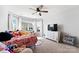 Well-lit bedroom featuring carpet, a ceiling fan, a window, and a television atop a dresser at 12028 Regal Lily Ln, Huntersville, NC 28078