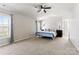 Spacious bedroom featuring a large window, a bed with decorative pillows, and a ceiling fan at 12028 Regal Lily Ln, Huntersville, NC 28078