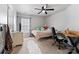 Bright bedroom featuring a ceiling fan, plush rug, and a cozy bed with decorative pillows at 12028 Regal Lily Ln, Huntersville, NC 28078