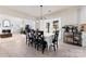 Bright dining area with white table cloth and French doors leading to a backyard oasis and view into the living room at 12028 Regal Lily Ln, Huntersville, NC 28078