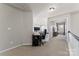 Bright hallway featuring a desk and office chair, with views into other rooms of the home at 12028 Regal Lily Ln, Huntersville, NC 28078