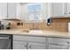 Close up view of a kitchen sink with modern fixtures, light colored countertops, and white cabinetry at 12028 Regal Lily Ln, Huntersville, NC 28078