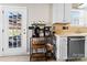 Cozy kitchen nook featuring a coffee bar, stainless steel dishwasher, and easy access to outdoor seating at 12028 Regal Lily Ln, Huntersville, NC 28078