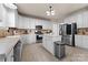 Well-lit kitchen featuring stainless steel appliances, ample white cabinetry, and a kitchen island at 12028 Regal Lily Ln, Huntersville, NC 28078