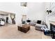 Bright living room featuring a fireplace and view into the kitchen and entry hall with staircase at 12028 Regal Lily Ln, Huntersville, NC 28078