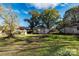 View of a expansive backyard with mature trees creating a serene backdrop and clear sky at 1216 E Cedar Ave, Gastonia, NC 28054