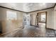 Bright living room with vintage ceiling fan, door to outside, and window with natural light at 1216 E Cedar Ave, Gastonia, NC 28054