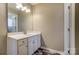 Bathroom featuring a white vanity with a large mirror at 12332 Ridge Cove Cir, Charlotte, NC 28273