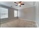 Bedroom with large window, ceiling fan, and neutral carpet at 12332 Ridge Cove Cir, Charlotte, NC 28273