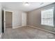 A bedroom with neutral carpeting and a door for a private exit at 12332 Ridge Cove Cir, Charlotte, NC 28273