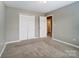 A bright bedroom with neutral carpet, white trim and two large closets at 12332 Ridge Cove Cir, Charlotte, NC 28273