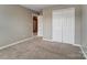 A light-filled room with neutral carpet and a double closet at 12332 Ridge Cove Cir, Charlotte, NC 28273