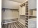 Spacious walk-in closet with custom shelving and wood-look flooring at 12332 Ridge Cove Cir, Charlotte, NC 28273