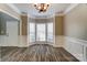 Dining room featuring a bay window, chandelier and wood-look floors at 12332 Ridge Cove Cir, Charlotte, NC 28273