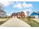 Wide view of a brick two-story home featuring a spacious driveway and traditional suburban setting at 12332 Ridge Cove Cir, Charlotte, NC 28273