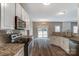 Open-concept kitchen featuring stainless steel appliances, granite countertops, and luxury vinyl flooring at 12332 Ridge Cove Cir, Charlotte, NC 28273