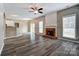 Open-concept living room with fireplace, flowing seamlessly into the dining area and kitchen at 12332 Ridge Cove Cir, Charlotte, NC 28273