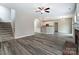 Modern living room with stairs, showcasing an open layout that flows into kitchen and dining spaces at 12332 Ridge Cove Cir, Charlotte, NC 28273