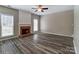 Bright living room features a brick fireplace, neutral walls, and large windows at 12332 Ridge Cove Cir, Charlotte, NC 28273