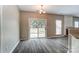 Bright living room featuring luxury vinyl flooring, a fireplace, and sliding glass doors leading to the backyard at 12332 Ridge Cove Cir, Charlotte, NC 28273