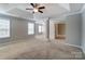 Spacious main bedroom featuring tray ceilings, fan, and ample natural light at 12332 Ridge Cove Cir, Charlotte, NC 28273