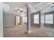 Spacious main bedroom with tray ceiling, fan, and a glimpse of the en-suite bath at 12332 Ridge Cove Cir, Charlotte, NC 28273