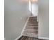 Carpeted staircase leading to the upper level of the home with natural light from a window at 12332 Ridge Cove Cir, Charlotte, NC 28273