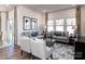 Spacious living room featuring two sofas, coffee table, large windows, and elegant decor at 1253 Morehead Dr, Salisbury, NC 28144