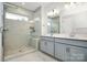 Bathroom with dual sink vanity and frameless glass shower at 1270 Brawley School Rd # E, Mooresville, NC 28177