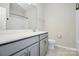 Bathroom with gray vanity, white countertops, toilet and shower/tub combo at 1270 Brawley School Rd # E, Mooresville, NC 28177