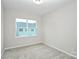 Cozy bedroom with neutral carpet, window, and natural light at 1270 Brawley School Rd # E, Mooresville, NC 28177