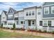 Charming townhome with white picket fence, blue and gray siding, and landscaped garden bed at 1270 Brawley School Rd # E, Mooresville, NC 28177