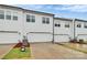 Rear view of townhome garages with clean, white doors and tidy landscaping at 1270 Brawley School Rd # E, Mooresville, NC 28177