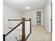 Second floor loft space with staircase and view into a bedroom at 1270 Brawley School Rd # E, Mooresville, NC 28177