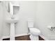 Modern powder room featuring a pedestal sink and toilet at 1270 Brawley School Rd # E, Mooresville, NC 28177